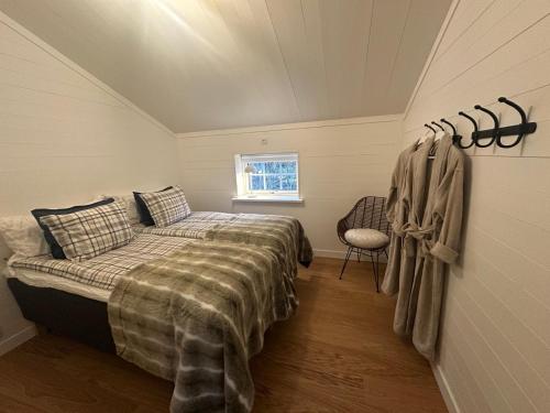 a bedroom with a bed and a chair in it at Bagargården7. bed & breakfast (Åre Bageri) in Åre