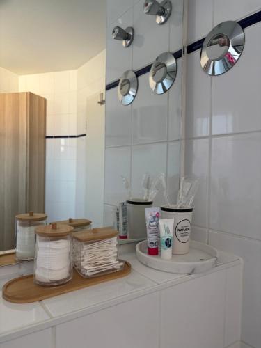 a bathroom with a counter with towels and a mirror at Zentrales, modernes Apartment mit Balkon, Küche & Garage in Dresden