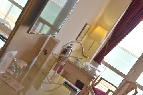 a hospital room with a lamp and a mirror at Ege Palas in İzmir