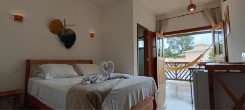 a bedroom with a bed with a butterfly on the wall at Pousada Real Cipo in Serra do Cipo