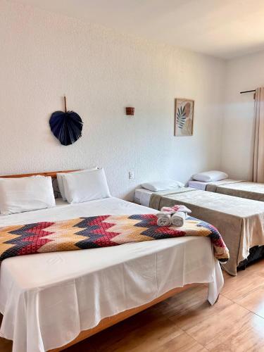 a bedroom with two beds and a couch at Pousada Real Cipo in Serra do Cipo