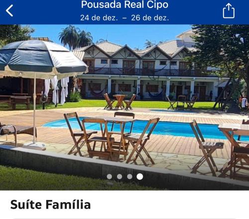 a website of a resort with a table and chairs next to a pool at Pousada Real Cipo in Serra do Cipo