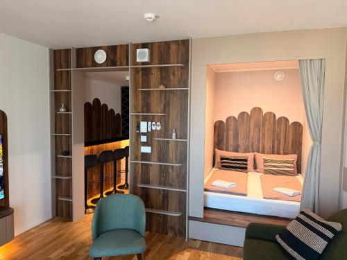 a bedroom with a bed in a wall with a mirror at Devana Premium Apartments by CHORS in Nivy