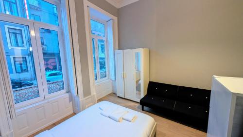 En eller flere senge i et værelse på Riko Guest House 2