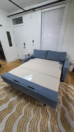 a large bed in a room with a carpet at Quiet cheerful condo in the heart of OTR! in Cincinnati