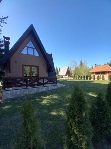ein Haus mit einem großen Garten davor in der Unterkunft Mountain House Tadić 3 in Bajina Bašta