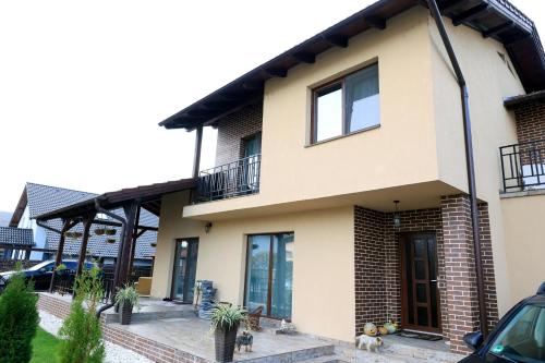 a house with two windows and a balcony at Casa Sofia in Livezeni