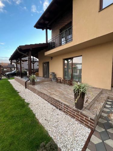 a house with a patio in front of it at Casa Sofia in Livezeni