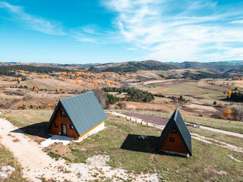 two barns on a hill with a view at Čarobna jutra Zlatara 2 in Radijevići