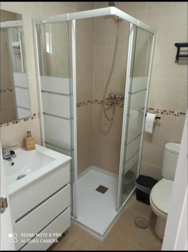 a bathroom with a shower and a sink and a toilet at Relax & Play Panoramic Golf Vinaroz, Sant Jordi Apartment in Vinarós