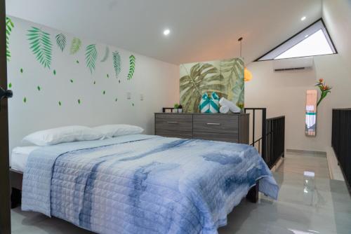 a bedroom with a bed with a blue comforter at Gival Paradise in Fortuna