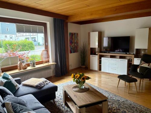 a living room with a couch and a table at FeWo Linneweber in Willingen