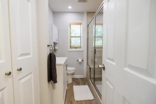 a bathroom with a toilet and a glass shower at Stylish Stay in the Heart of Decatur King Bed in Decatur
