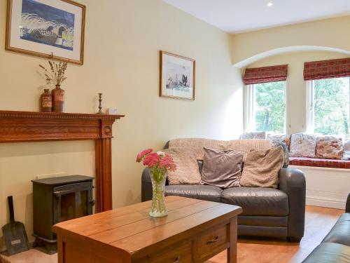 a living room with a couch and a table at Aira Cottage in Watermillock