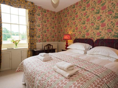 a bedroom with a bed with towels on it at Bell Flat - Uk42250 in Broughton