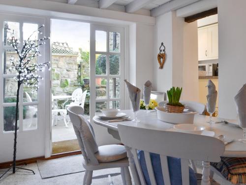a kitchen and dining room with a table and chairs at Toad Hall in Helmsley