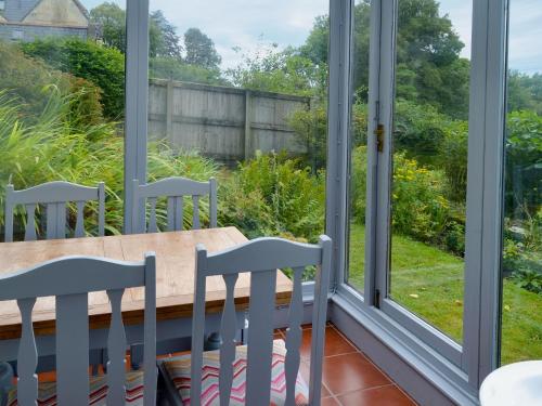 a view from the balcony of a house with a table and chairs at Eastwood Lodge in Bath