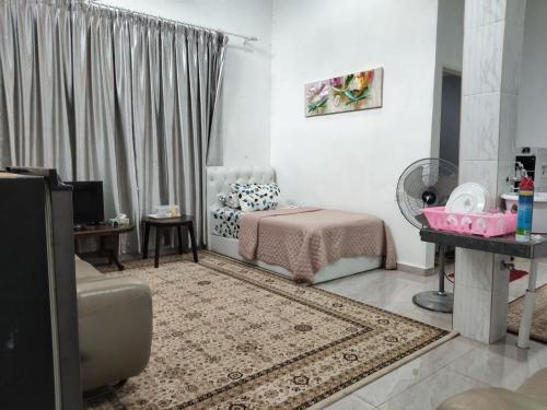 a living room with a bed and a couch at Makwan Homestay B in Kubang Semang