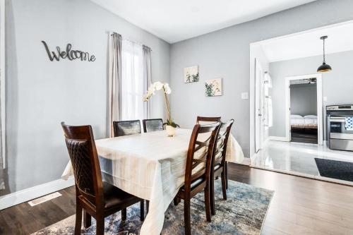 a dining room with a table and chairs at Modern 5BR Home Perfect for Families in Niagara Falls