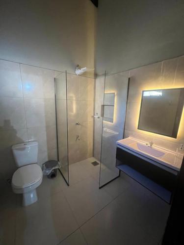 a bathroom with a toilet and a sink and a shower at San Antonio Home in San Antonio