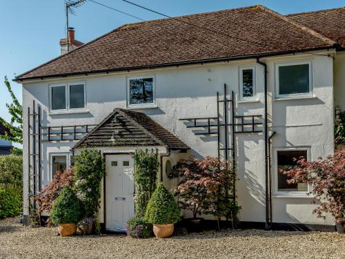 a white house with a cross in front of it at Yew Tree House in Chideock