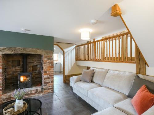 a living room with a couch and a fireplace at Uk46589 - Kibble in Church Stretton
