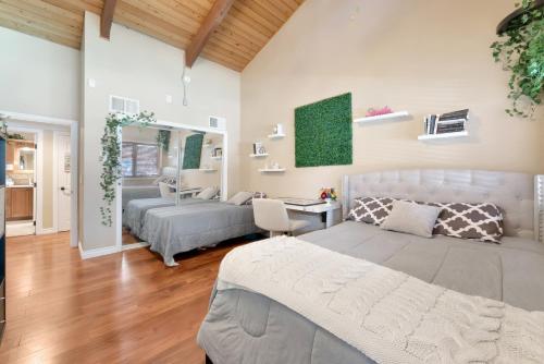 a bedroom with two beds and a living room at 1-Acre Las Vegas Getaway Pool, Spa and Tennis Court in Las Vegas