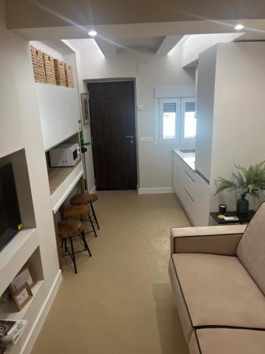 a living room with a couch and some chairs at Castillo 22 in Oropesa