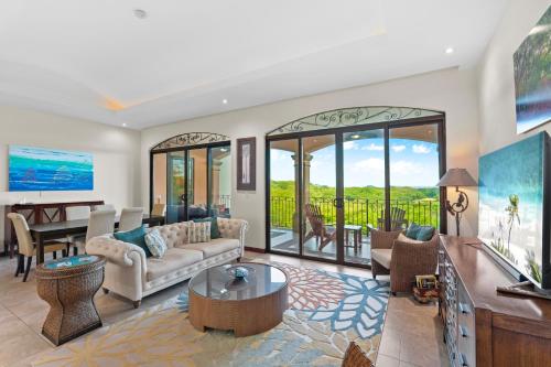 a living room with a couch and a table at Treetop Ocean View Penthouse - Jobo 15 in Playa Conchal