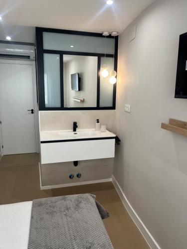 a bathroom with a sink and a mirror at Castillo 22 in Oropesa