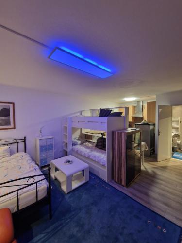 a bedroom with a bed and a blue light at quiet apartment 2 in Rüsselsheim