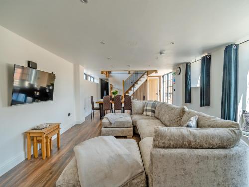 a living room with a couch and a table at Stable View Barn - Uk45938 in Corley