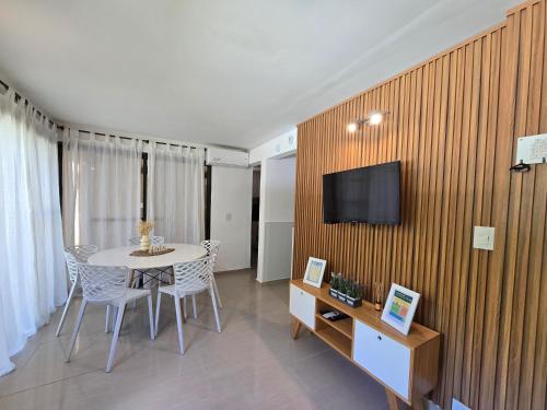 a room with a table and a tv on a wall at FlussHaus3 in Villa General Belgrano