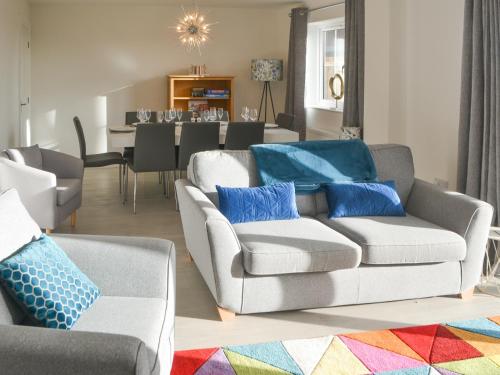 a living room with two couches and a dining room at Ad Gefrin in Acklington