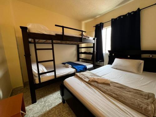 a bedroom with two bunk beds and a window at Casa Rincón in Curití