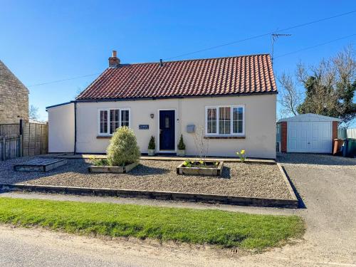 a white house with a red roof at Brookfields in Slingsby