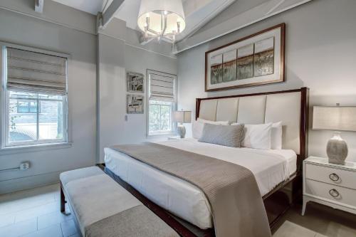 a bedroom with a large bed and a chandelier at Parker's Collection - 4 Bedroom in Savannah