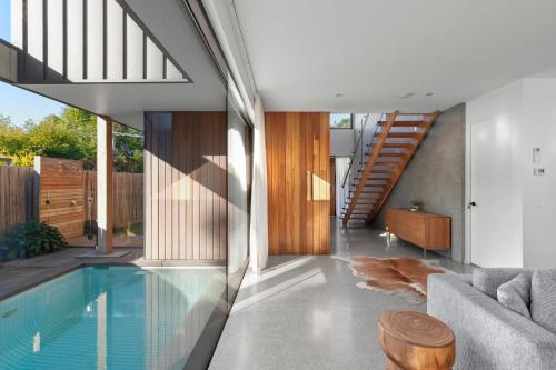 a house with a swimming pool in a living room at Riverhaus Luxe Barwon Heads Retreat with Pool in Barwon Heads