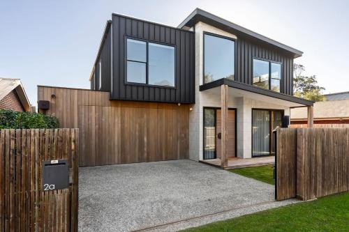a house with a black and white facade at Riverhaus Luxe Barwon Heads Retreat with Pool in Barwon Heads