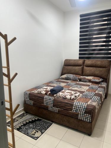 a brown couch in a room with a ladder at Avida Homestay in Kampong Jelatang