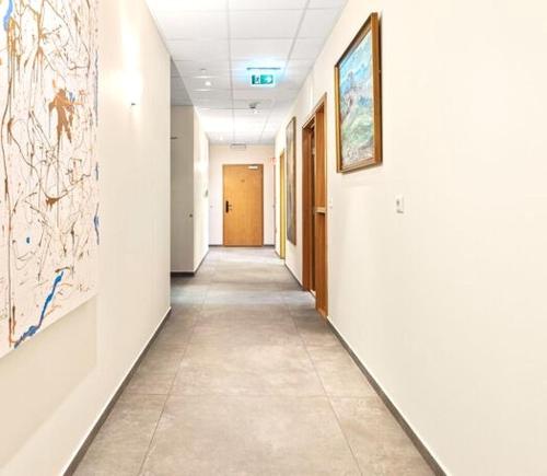 an empty hallway in an office with paintings on the walls at T10 Self check-in Hotel in Hafnarfjördur