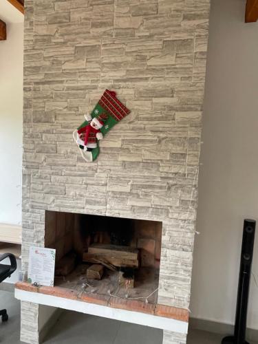 a santa claus ornament hanging on a stone fireplace at Villa Ancestral in Villa de Leyva
