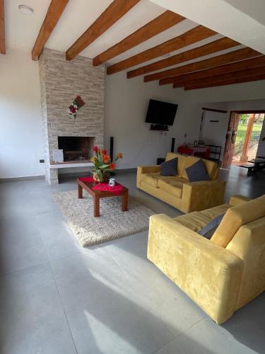 a living room with two couches and a fireplace at Villa Ancestral in Villa de Leyva