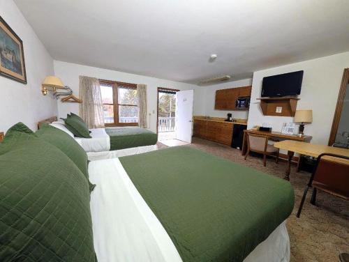 a hotel room with two beds and a kitchen at Cool City Motel in Two Rivers
