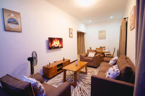 een woonkamer met een bank en een open haard bij FREEDOM homes in Arusha