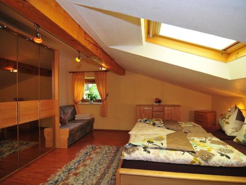 a bedroom with a large bed and a couch at Holiday apartment with 2 bedrooms in Fulpmes