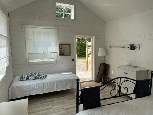 a bedroom with a bed and a window and a table at 6 person holiday home in SVANESUND in Buvik
