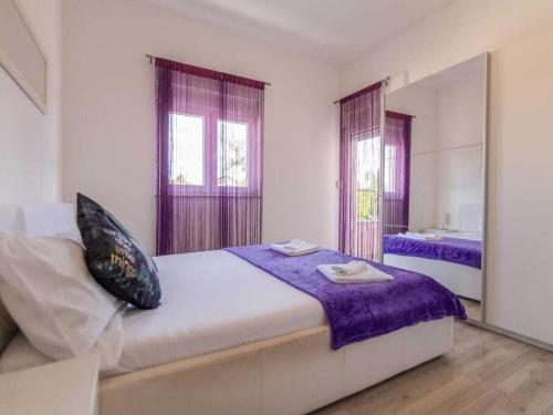 a bedroom with a large bed and a mirror at Cecilia with pool in Nenadići