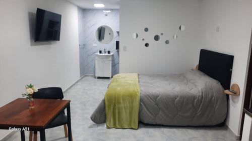 a bedroom with a bed and a table and a mirror at Rada Tilly Apart 2 Unidad 6 in Rada Tilly