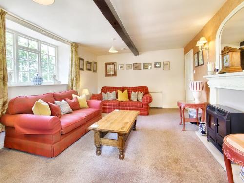 a living room with a red couch and a table at Carriage House - E5119 in West Burton